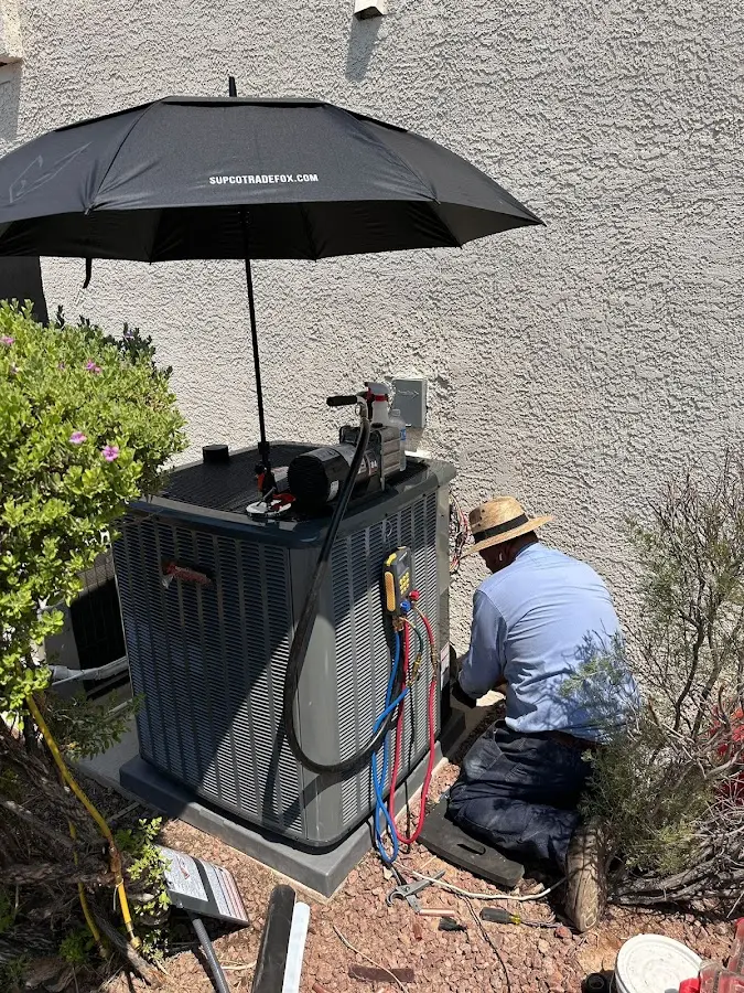 HVAC technician performing outdoor AC maintenance in Monterey