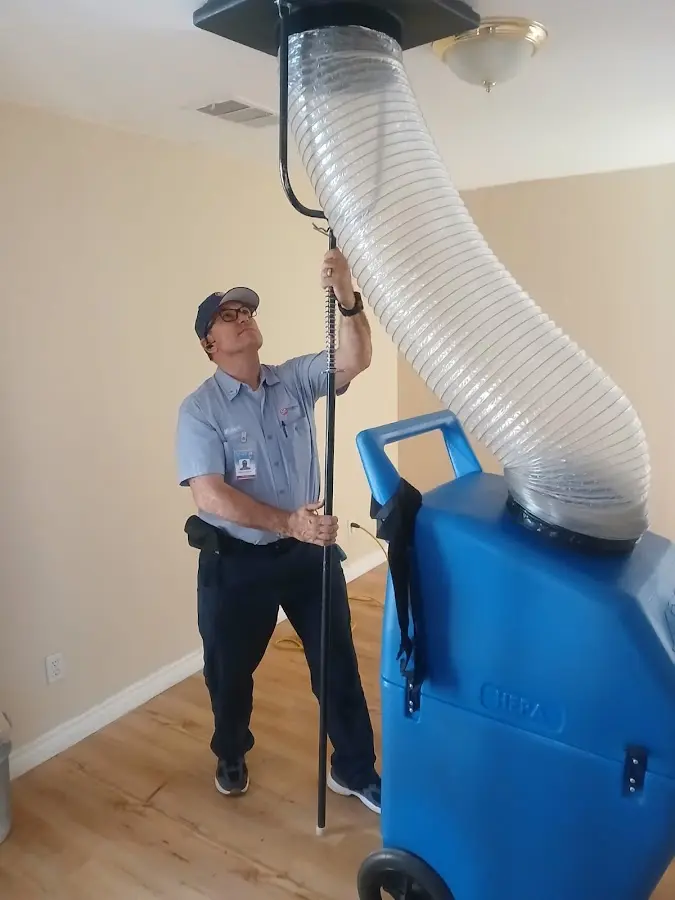 Furnace Tune-Up technician using HEPA equipment in Monterey